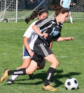 Elite girls club soccer players compete.