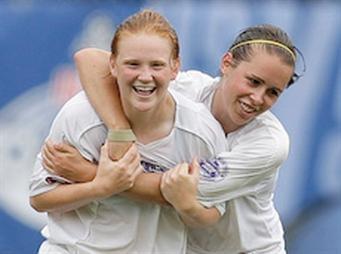 Girls club soccer players celebrate.